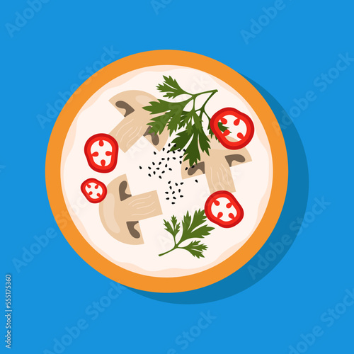 Tom kha kai with mushrooms, pepper and coconut milk. Spicy and sour Thai soup on blue background.