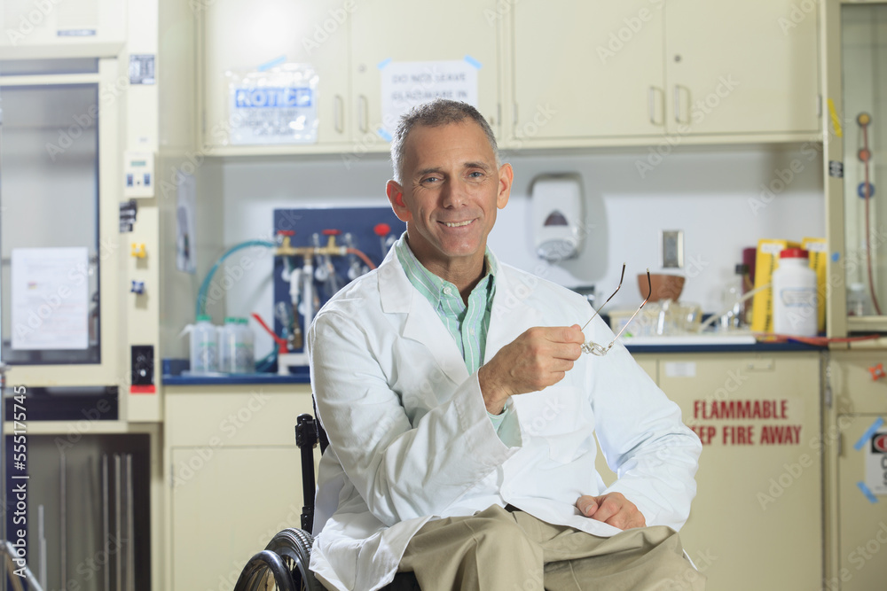 Portrait of a smiling professor with a spinal cord injury in a wheelchair Portrait of a smiling professor with a spinal cord injury in a wheelchair