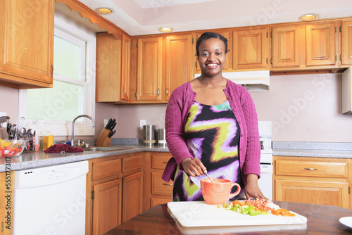 Woman with learning disability cooking in the kitchen photo