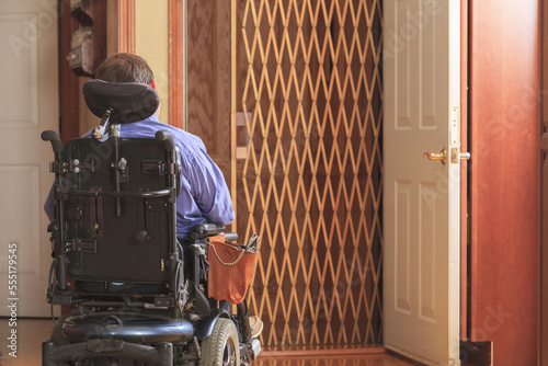 Man with Cerebral Palsy entering a home elevator
