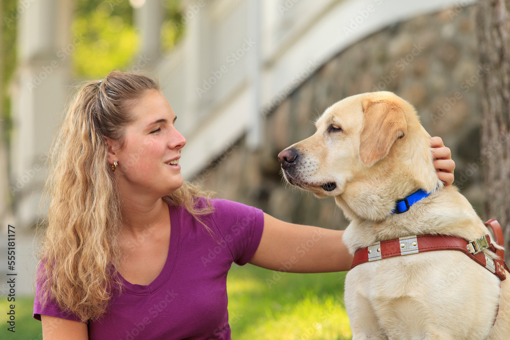 Woman with visual impairment petting her service dog Woman with visual impairment petting her service dog