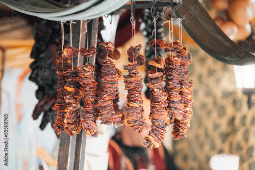 Smoked dried spanish nora peppers hanged in street market.