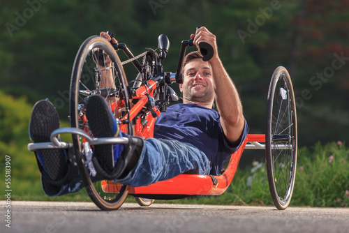 Man with spinal cord injury on his custom adaptive hand cycle photo