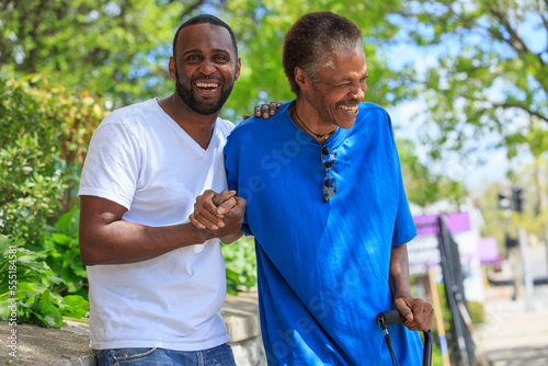 Man with Traumatic Brain Injury with cane enjoying his friend photo