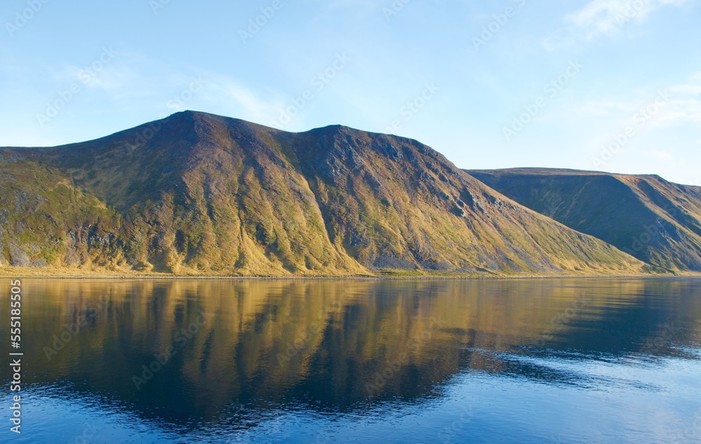 Reflection of mountains on the water in the fjords in Norway