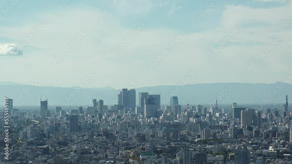 NAGOYA, JAPAN - OCTOBER 2022 : Aerial high angle view of NAGOYA CITY in sunny daytime. View of buildings and street traffic around Nagoya station and Sakae area (central downtown). Time lapse shot. NAGOYA, JAPAN - OCTOBER 2022 : Aerial high angle view of NAGOYA CITY in sunny daytime. View of buildings and street traffic around Nagoya station and Sakae area (central downtown). Time lapse shot.