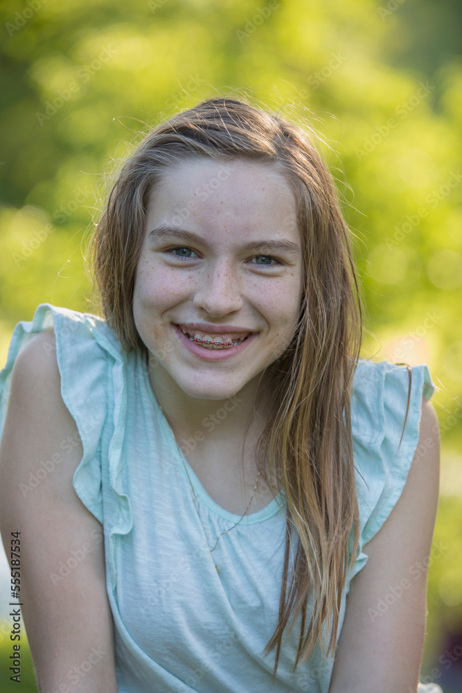 Portrait of happy Hispanic teen girl with braces in park Portrait of happy Hispanic teen girl with braces in park