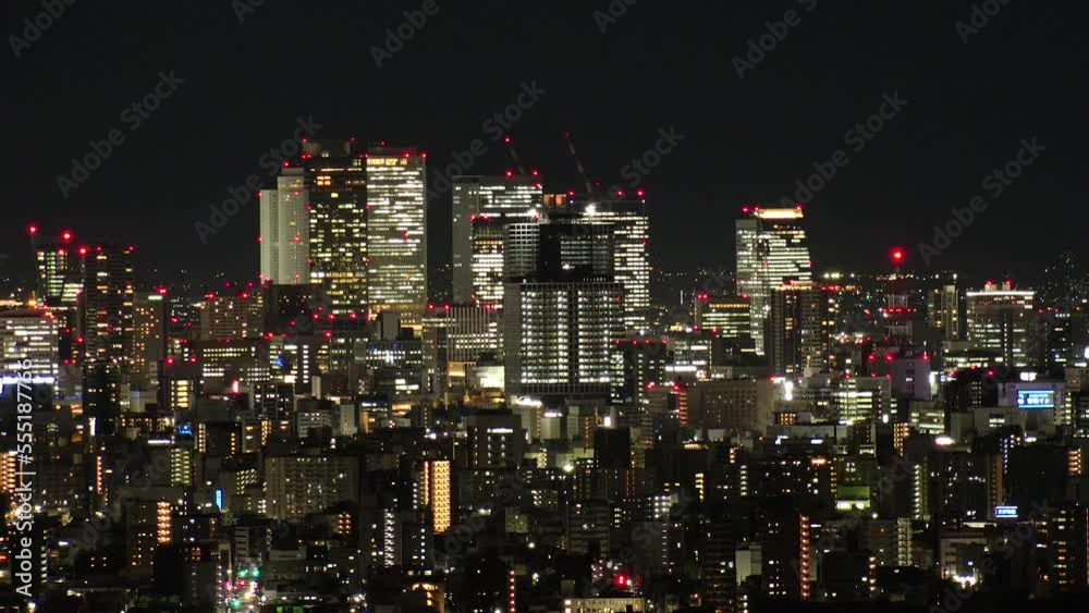 NAGOYA, JAPAN- OCT 2022 : Aerial high angle view of NAGOYA CITY at night. Buildings and street traffic around Nagoya station and Sakae area (central downtown). Time lapse shot. Travel concept video. NAGOYA, JAPAN- OCT 2022 : Aerial high angle view of NAGOYA CITY at night. Buildings and street traffic around Nagoya station and Sakae area (central downtown). Time lapse shot. Travel concept video.