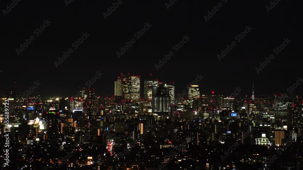 NAGOYA, JAPAN- OCT 2022 : NAGOYA CITY at night. Aerial high angle view of buildings and street traffic around Nagoya station and Sakae area (central downtown). Time lapse shot. Travel concept video.