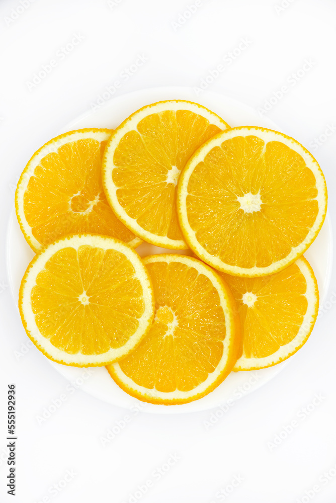 Sliced orange slices on a white plate. Orange slices on a white background. Oranges close-up. Sliced orange slices on a white plate. Orange slices on a white background. Oranges close-up.