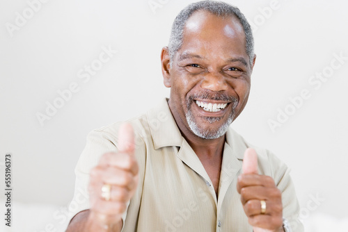 Portrait of a middle-aged man making a Thumbs Up sign and smiling
