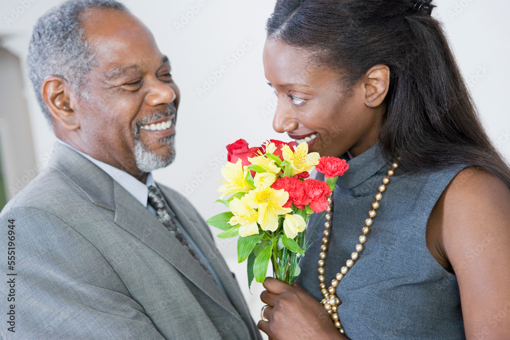 Side profile of a middle-aged couple looking at each other and smiling Side profile of a middle-aged couple looking at each other and smiling