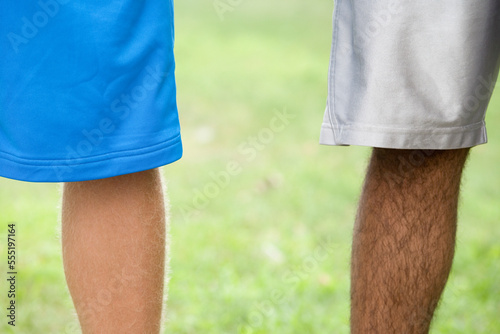 Low section view of two teenage boys wearing shorts photo