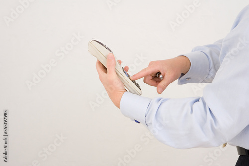 Mid section view of a businessman operating an adding machine tape photo