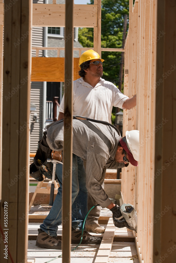 Carpenters building framing using nail gun Carpenters building framing using nail gun