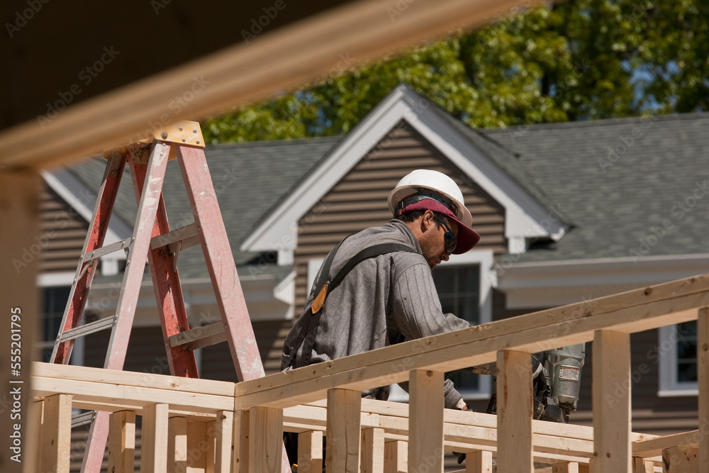 Carpenter using nail gun on framing Carpenter using nail gun on framing