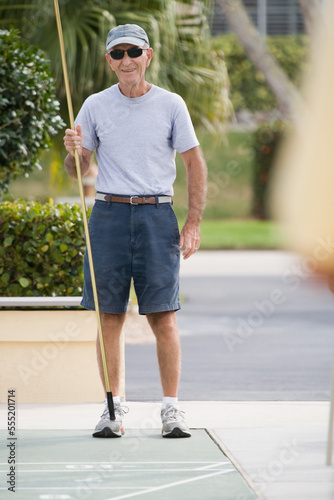 Senior man playing shuffleboard