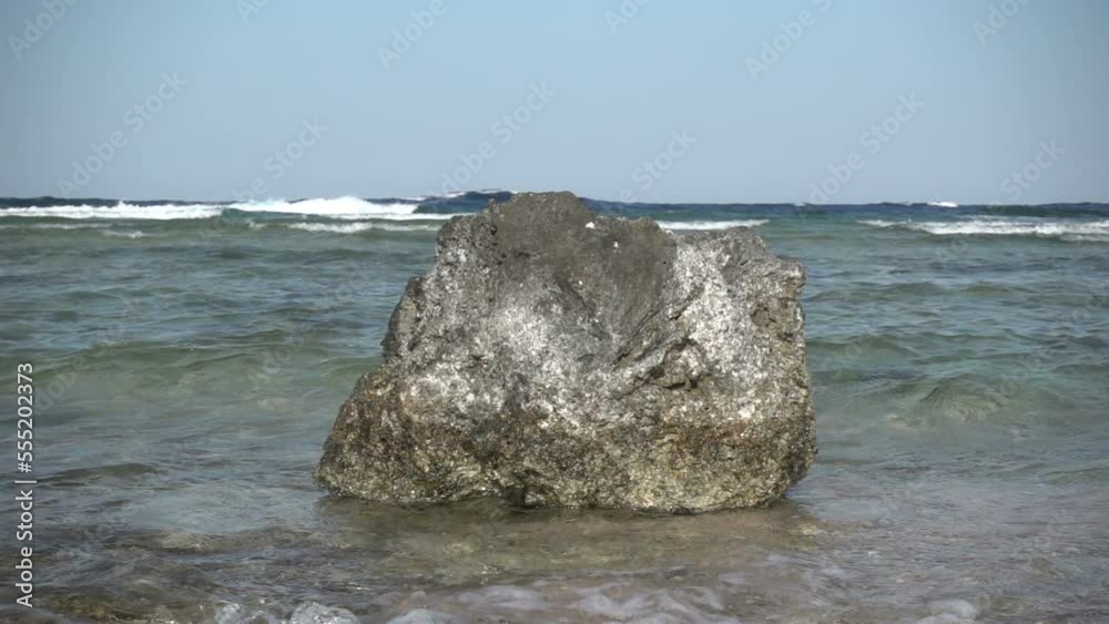 Slow motion of beautiful sea waves breaking on dead corals on the shore