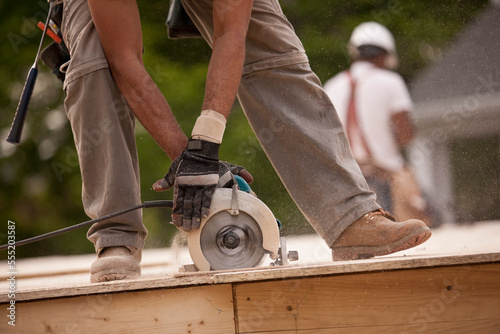 Carpenter sawing a board