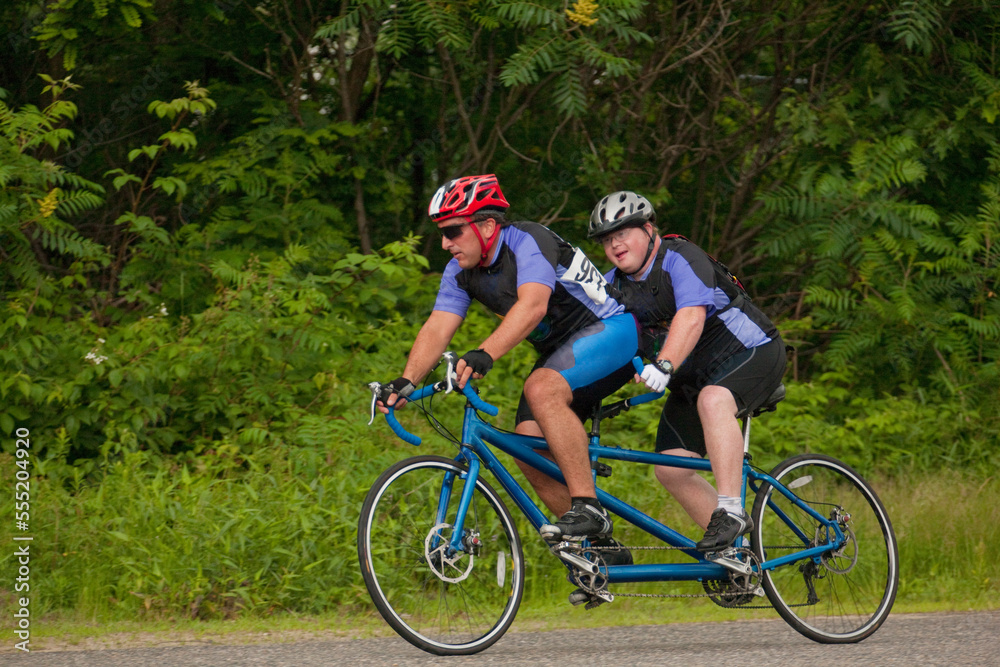 Tandem disability racers; 'Pilot' in front and man with disability in back Tandem disability racers; 'Pilot' in front and man with disability in back