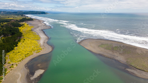 Aerial shot of the point where the river Tolten flows into the pacific ocean in Araucania, Chile 