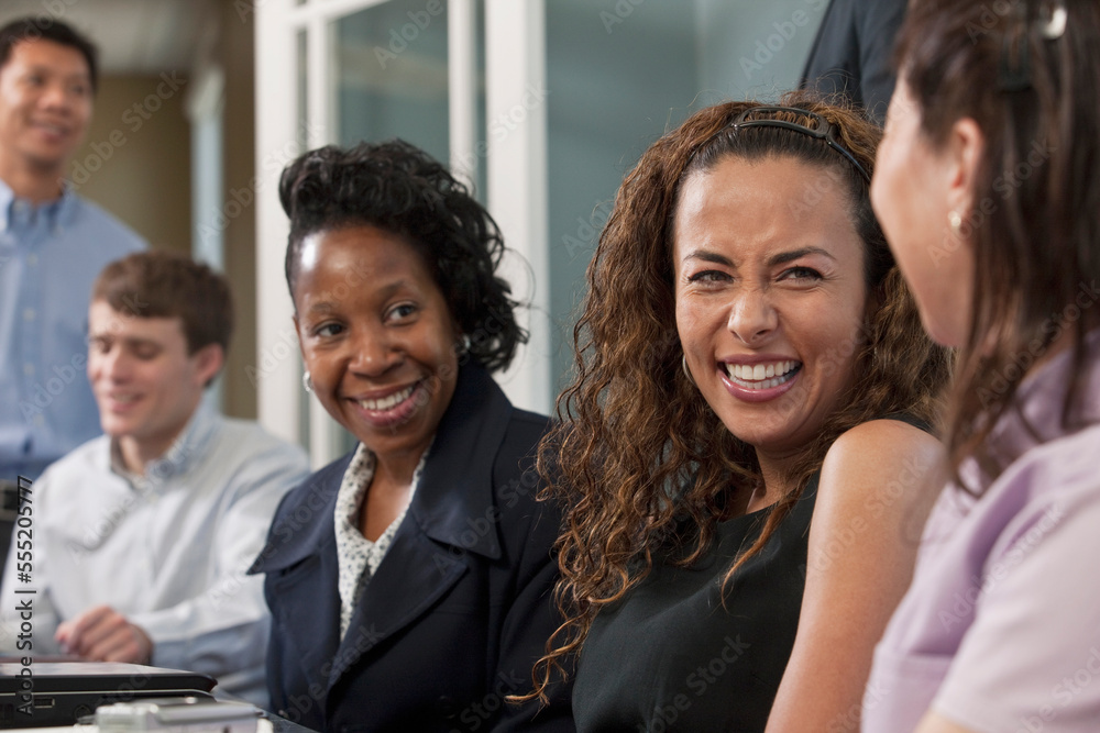 Visually impaired Hispanic businesswoman with her colleagues in a board room Visually impaired Hispanic businesswoman with her colleagues in a board room