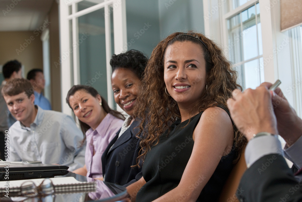 Visually impaired Hispanic businesswoman with her colleagues in a board room Visually impaired Hispanic businesswoman with her colleagues in a board room