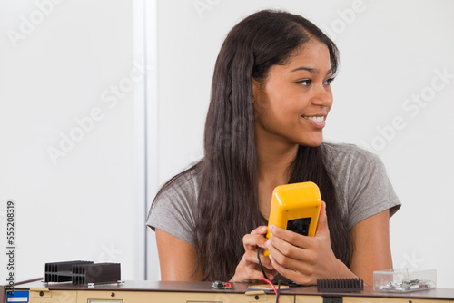 Engineering student using a multimeter photo