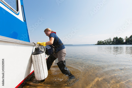 Public works engineer preparing to take public water samples from reservoir photo