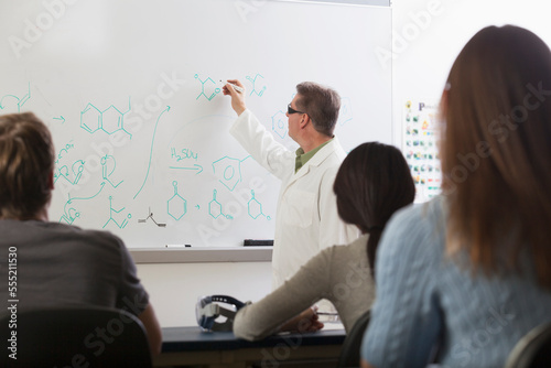 Students seated in an engineering classroom listening to professor discuss chemical Benzene ring bonds photo