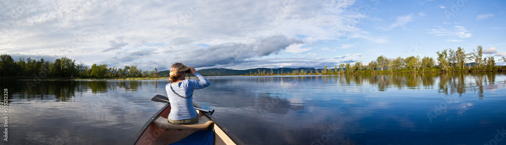 Woman in canoe at Lake Umbagog, New Hampshire, USA Woman in canoe at Lake Umbagog, New Hampshire, USA