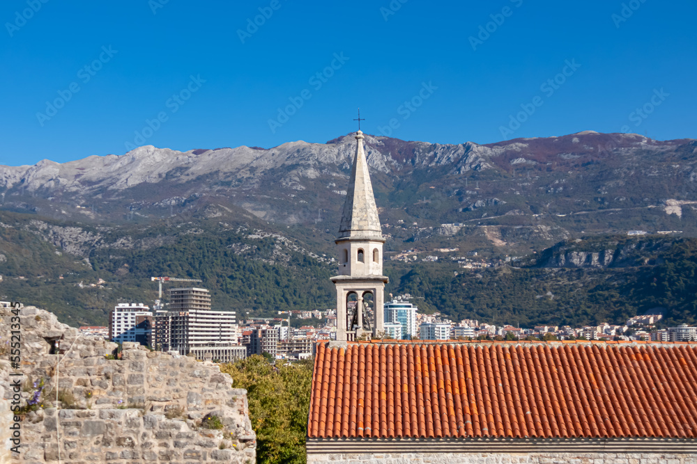 Panoramic view of medieval historic city centre and Venetion old tower of Budva seen from the Citadel, Adriatic Sea, Montenegro, Balkan peninsula, Europe. Mountains of Dinaric Alps in background