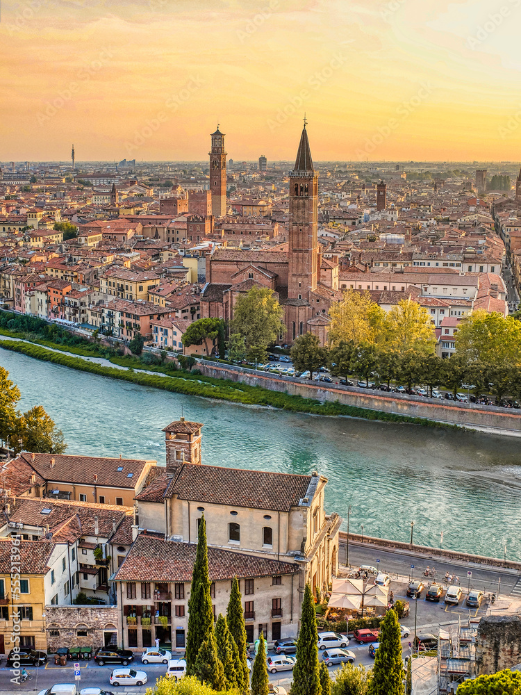 Verona, Veneto, Italy. The historic center of Verona crossed by the Adige river. View from San Pietro hill at sunset.