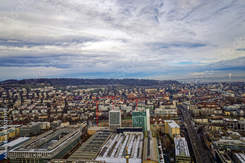 Aerial view of City of Zürich seen from industrial district with Waidberg and Käferberg in the background on a cloudy winter day. Photo taken December 20th, 2022, Zurich, Switzerland.