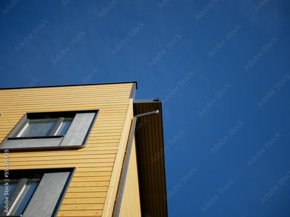 facade of an yellow building with blue sky