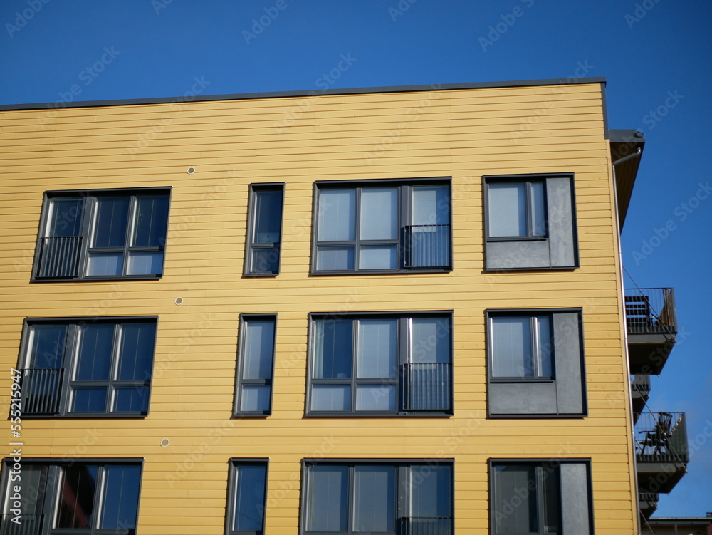 facade of an yellow building with blue sky