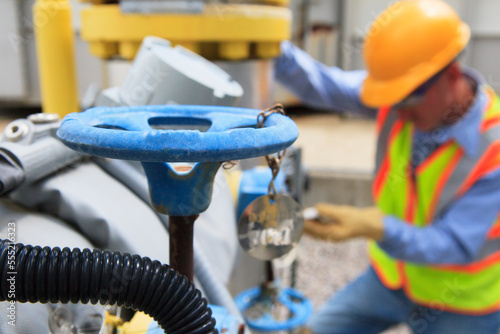 Engineer at electric power plant working with manual valves photo