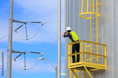 Industrial engineer on platform of a fuel tank at a power plant photo