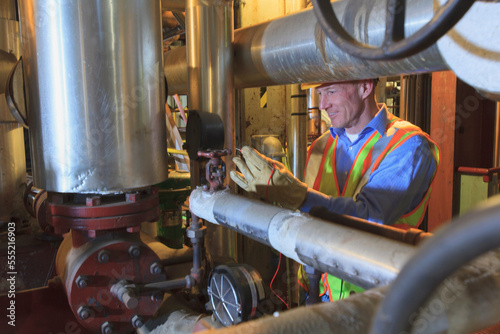 Engineer in electric power plant testing a transducer electrical signal photo