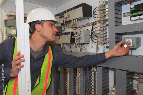 Industrial engineer checking programmable logic controllers at a power plant