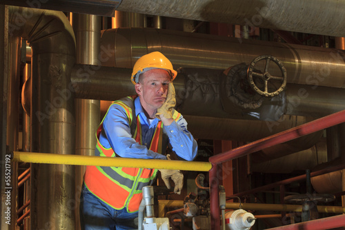 Engineer in electric power plant condenser room photo
