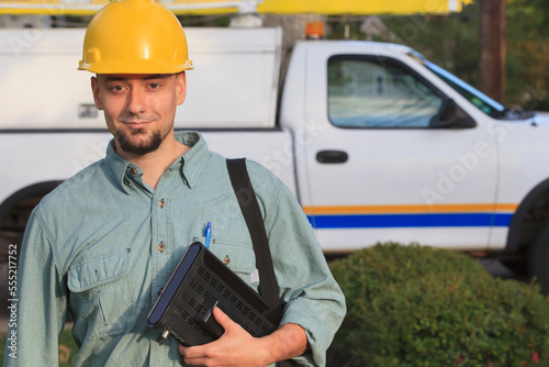 Portrait of lineman with cable box going to the house photo