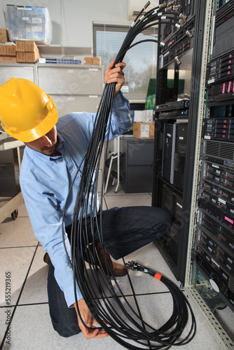 Network engineer preparing structured cabling for data center
