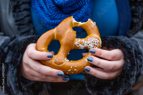 Woman eating a pretzel; New York City, New York, United States of America photo