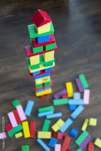 Colourful blocks stacked into a tower and dispersed on the floor at playtime; Surrey, British Columbia, Canada photo