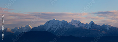 Golden Ears mountain peaks with a sunset glow as viewed from Surrey, BC; British Columbia, Canada photo