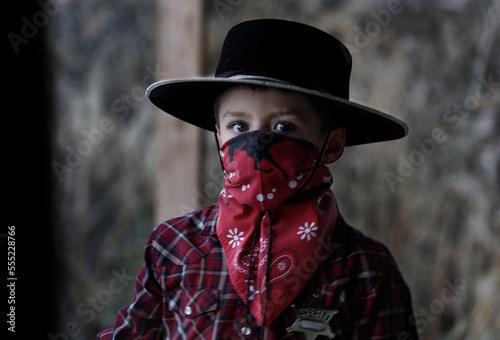 Boy poses in his cowboy outfit; Prineville, Oregon, United States of America photo