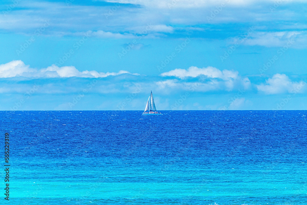 Lone sailboat in the middle of the blue, Pacific Ocean on a beautiful sunny day off the coast of Lahaina; Maui, Hawaii, United States of America Lone sailboat in the middle of the blue, Pacific Ocean on a beautiful sunny day off the coast of Lahaina; Maui, Hawaii, United States of America