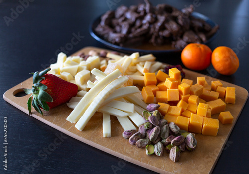 Variety of healthy foods ready to serve on a wooden board and plate; Studio photo