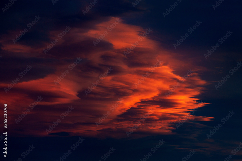 Very dramatic colourful clouds against a deep dark blue sky at sunset; Calgary, Alberta, Canada Very dramatic colourful clouds against a deep dark blue sky at sunset; Calgary, Alberta, Canada